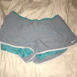 They are grey and turquoise running shorts.